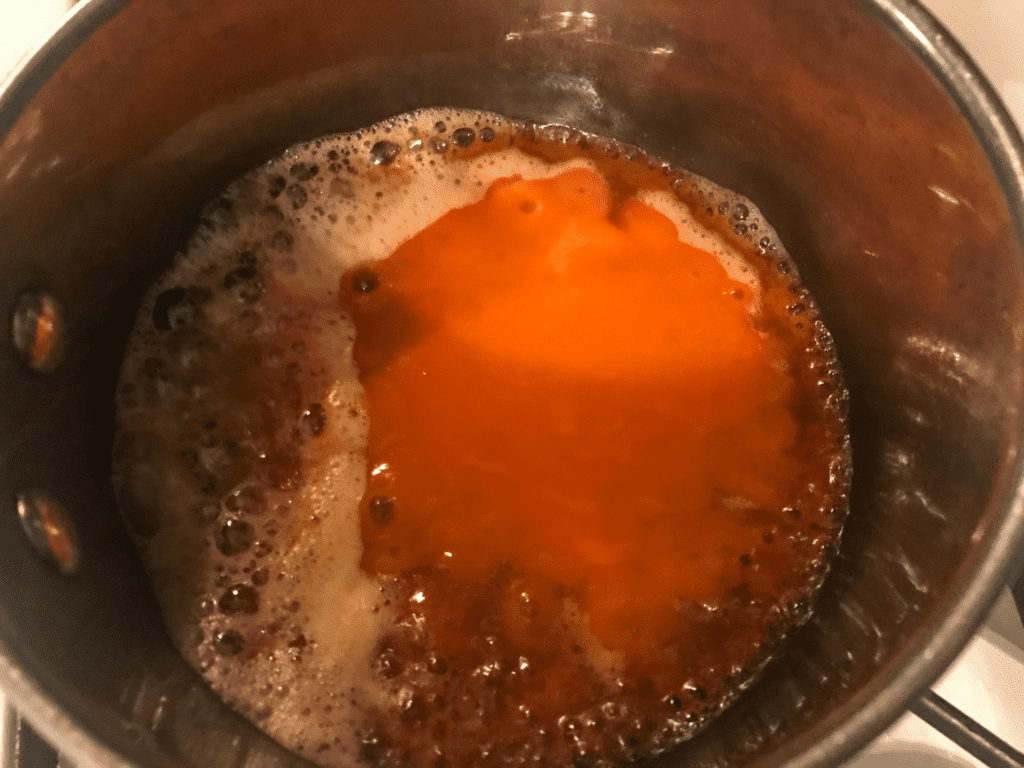 buffalo sauce added to melted butter in pot