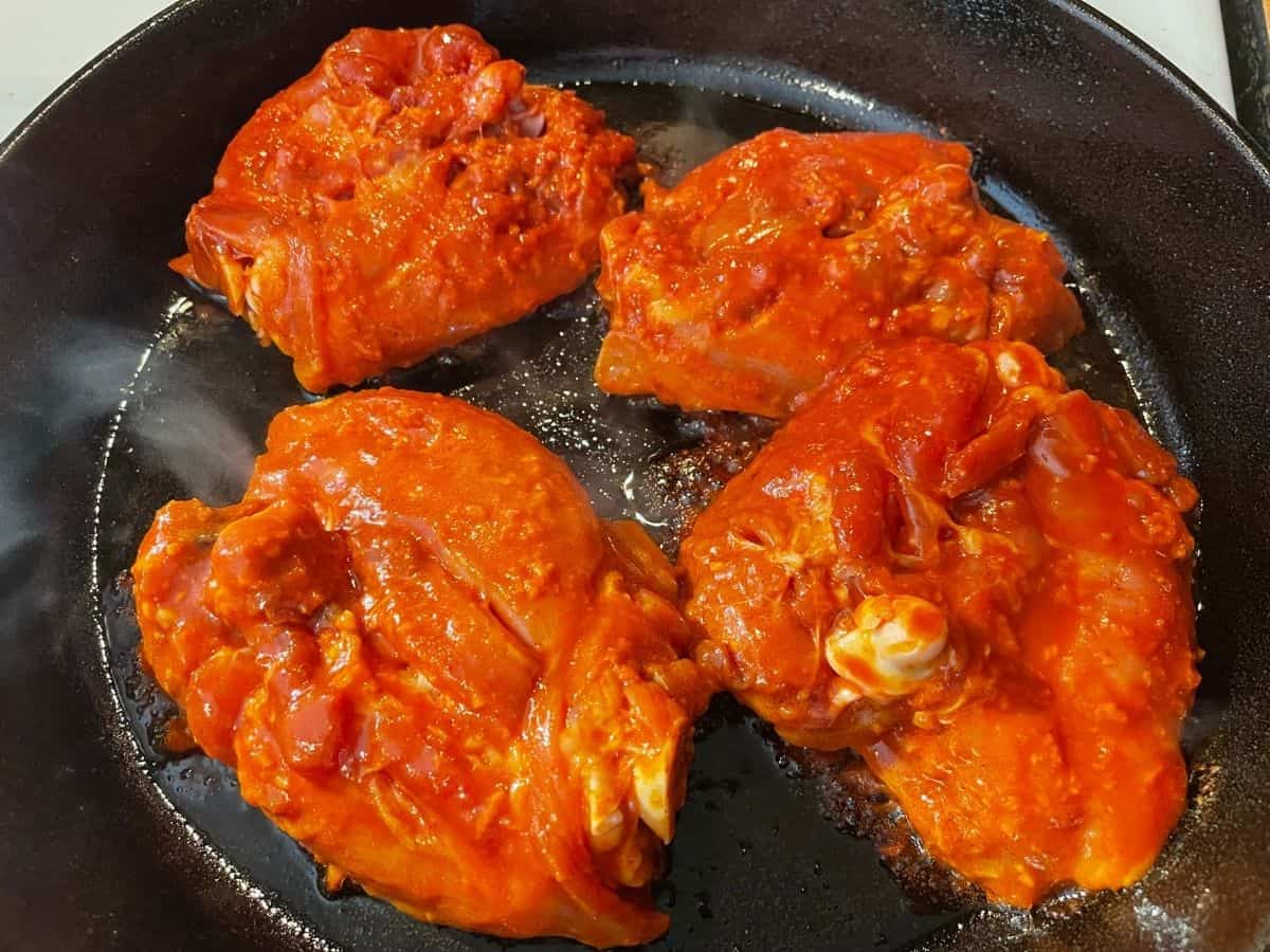 searing skin of chicken thighs