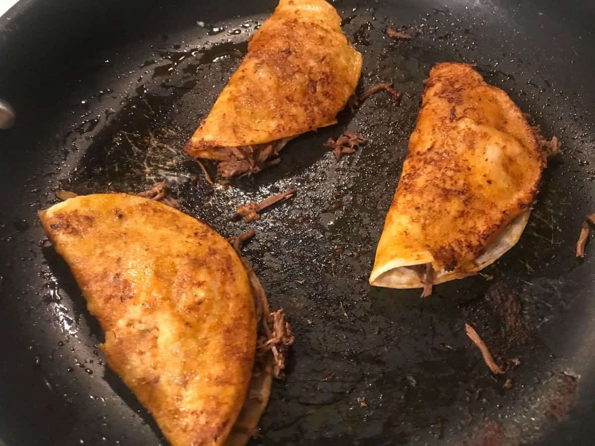 Birria Quesa Tacos frying in pan