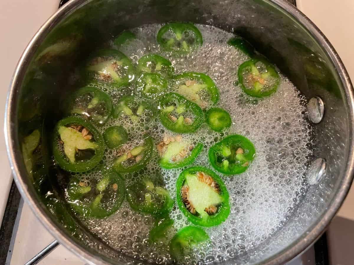 Jalapeño simple syrup boiling in saucepan