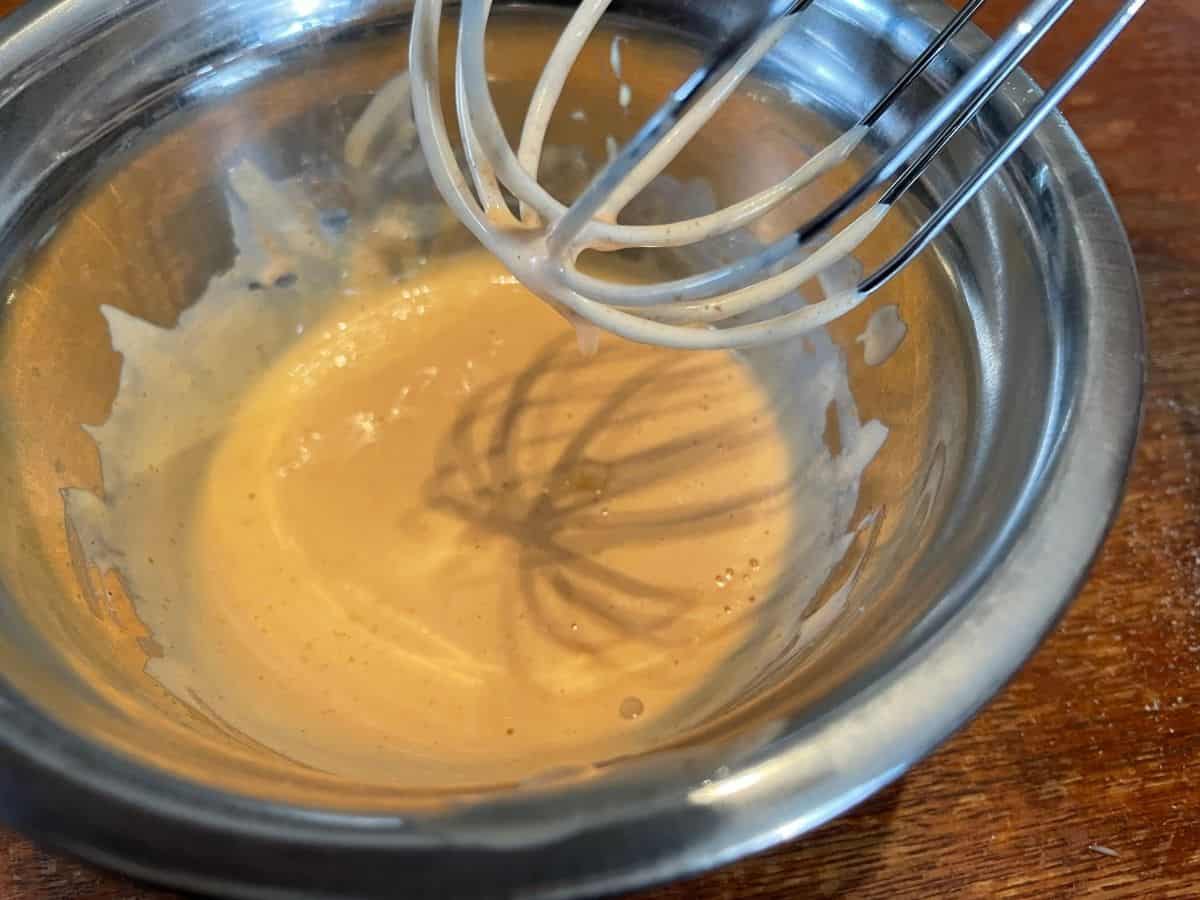 kani dressing mixed in a mixing bowl with whisk