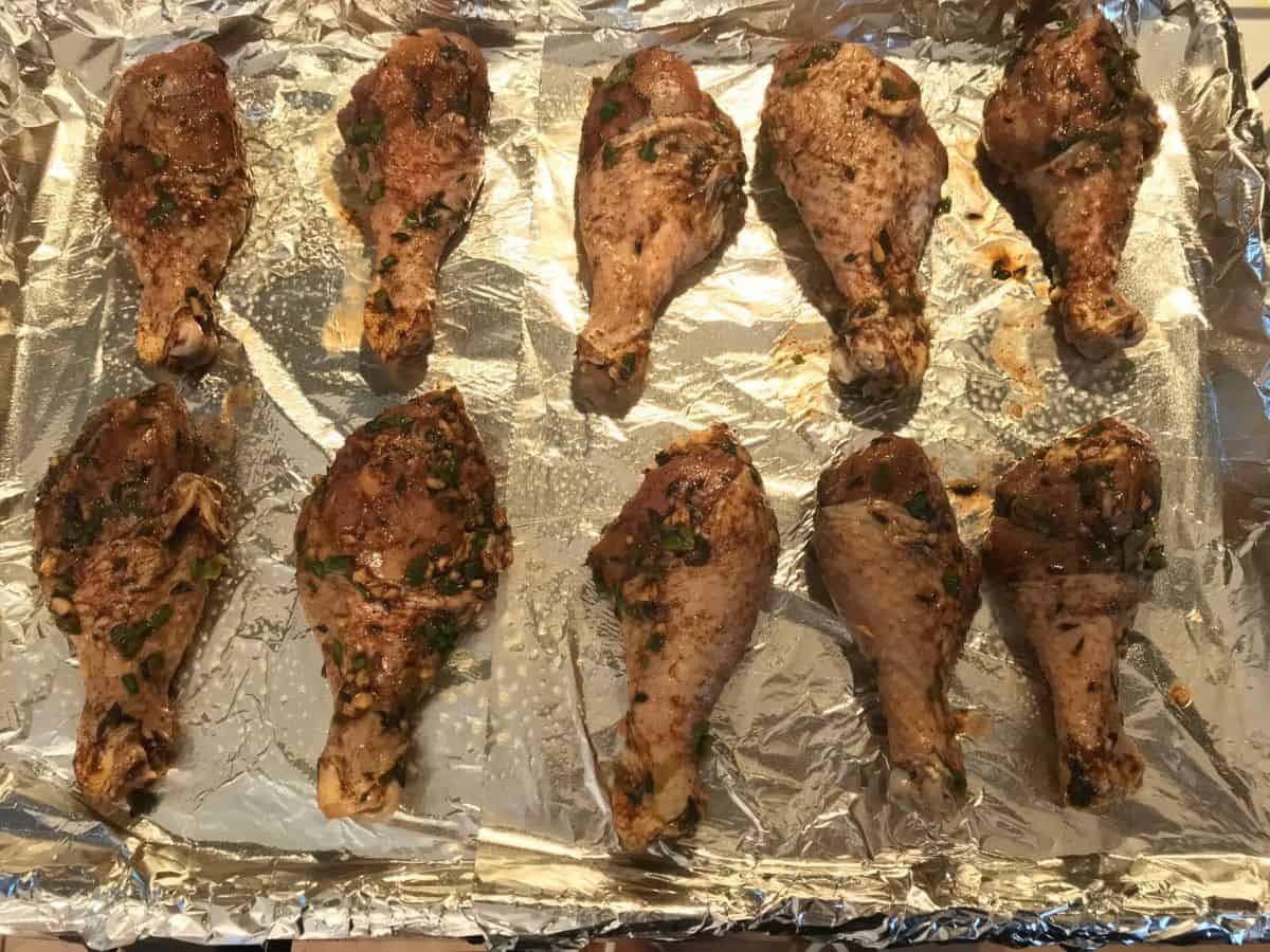 marinated jerk chicken on a foil lined sheet pan
