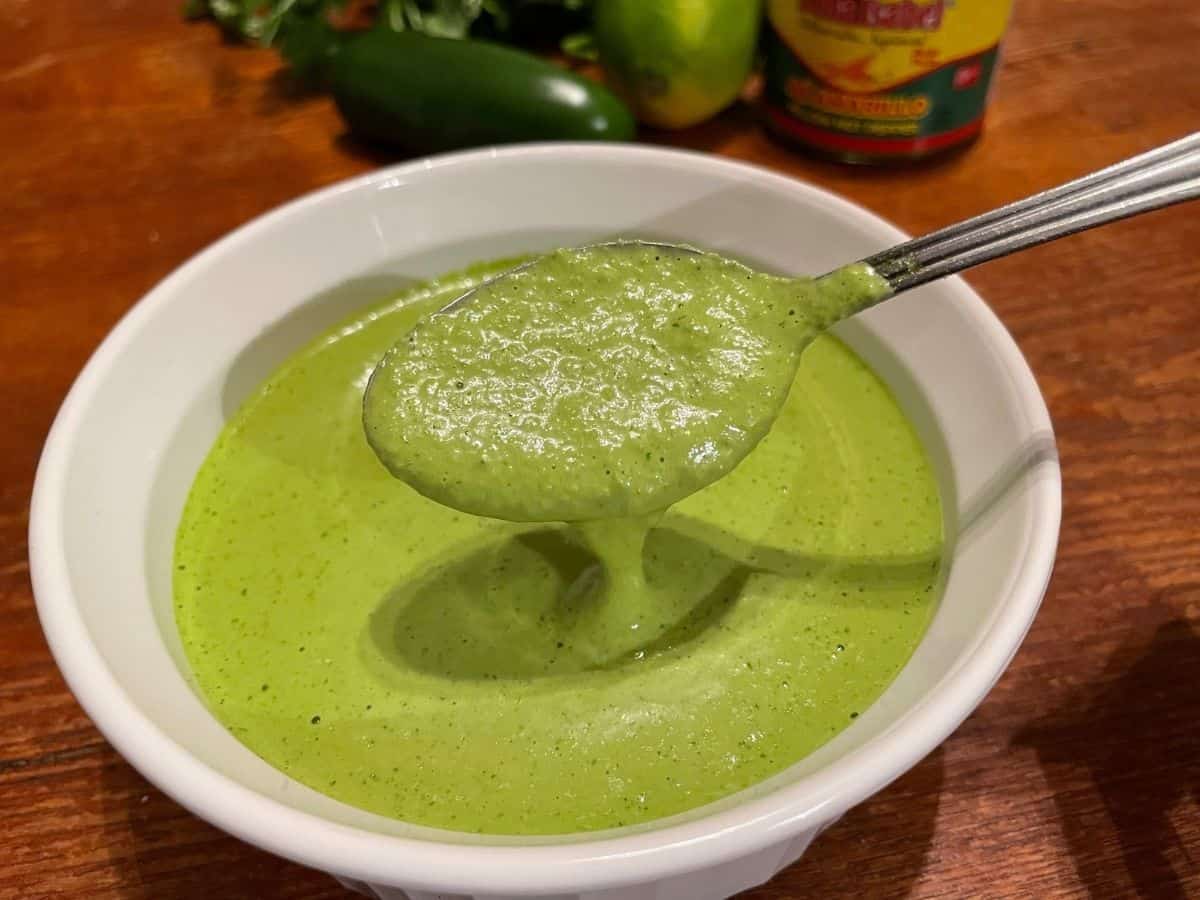 close up of a spoonful of green sauce