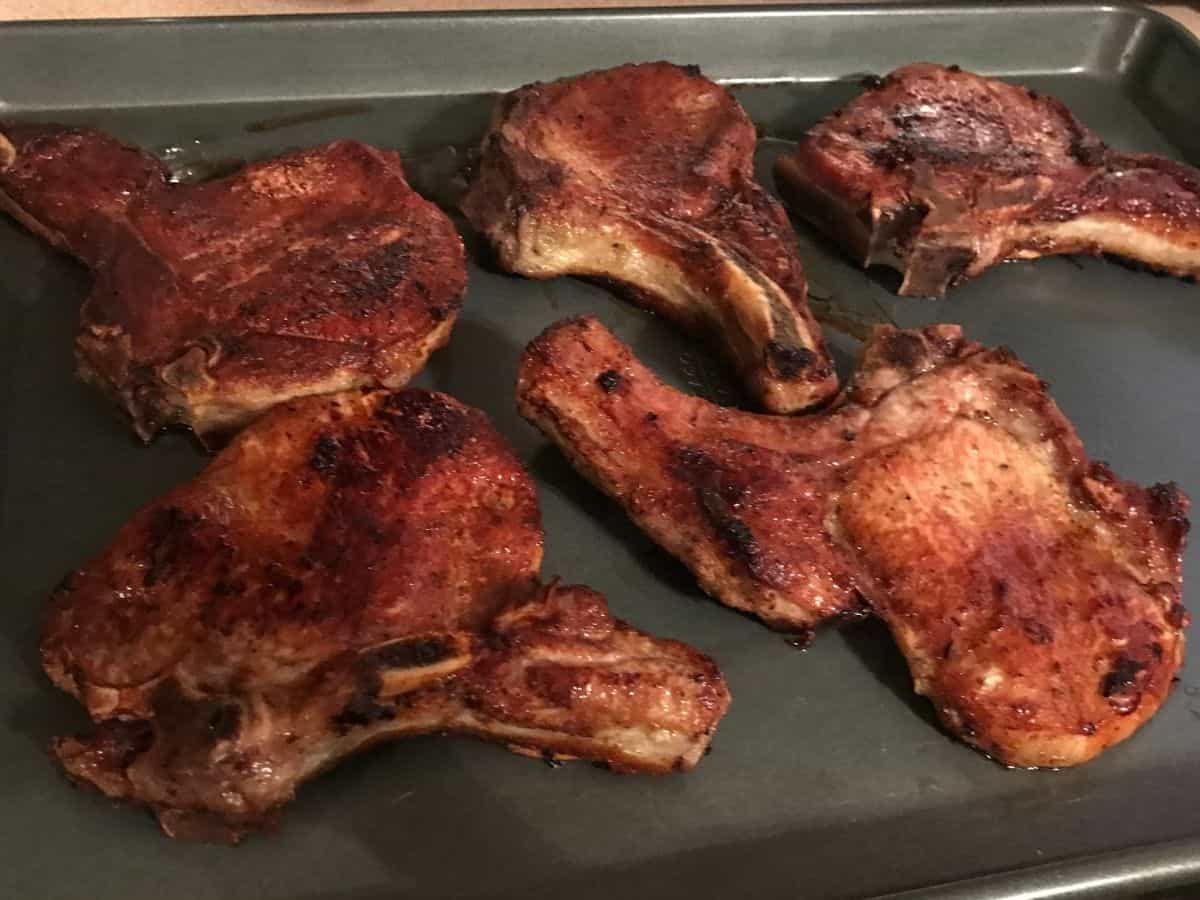 cooked pork chops on a baking sheet