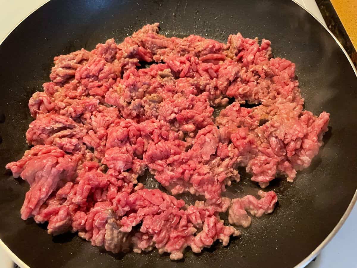 ground beef cooking in hot frying pan