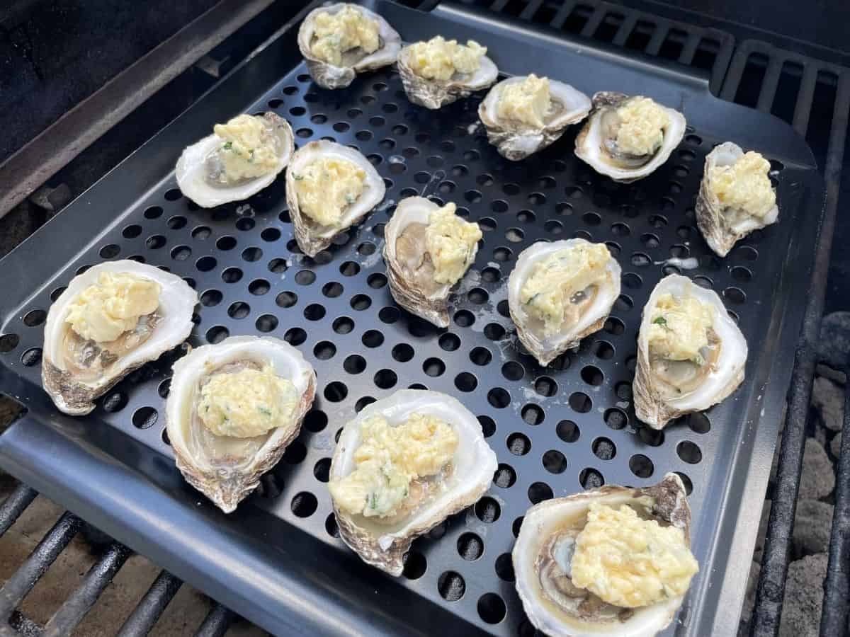 oysters on the grill with garlic butter on top