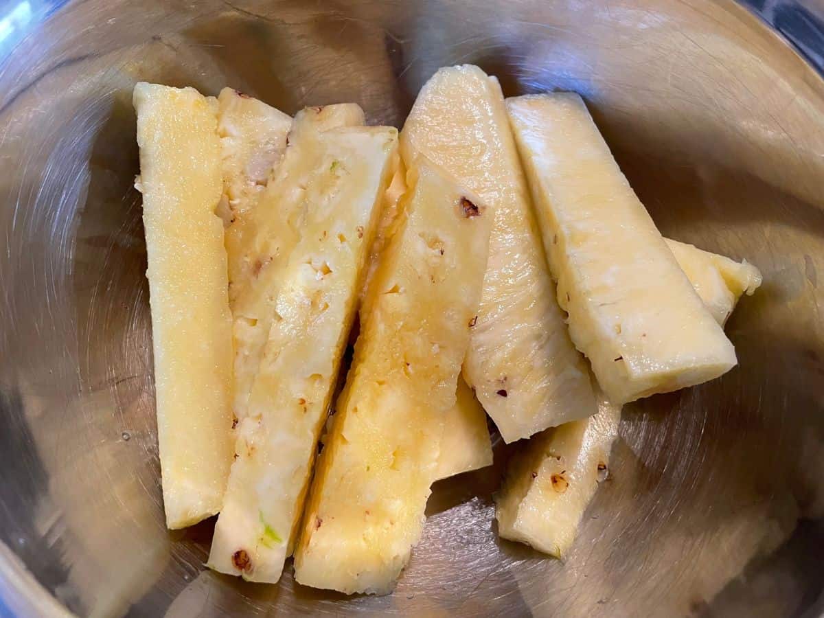 pineapple cut in to spears in a medium bowl