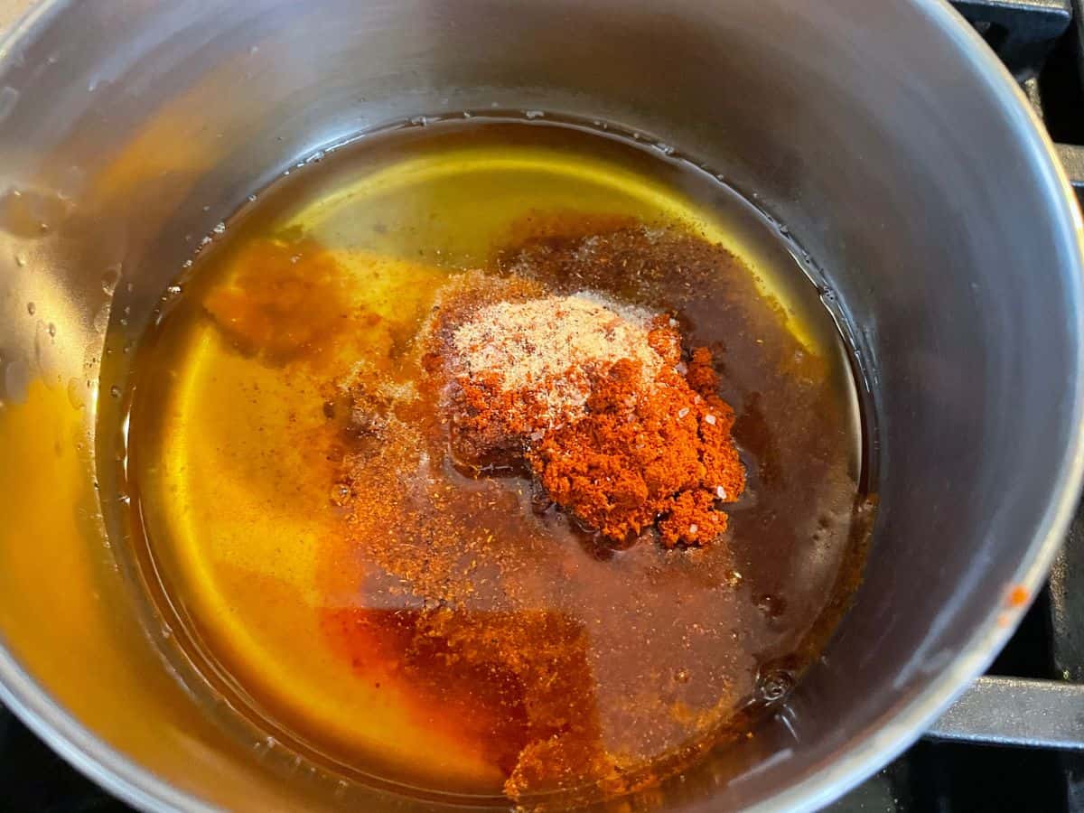 overhead shot of spicy oil ingredients in a small pot