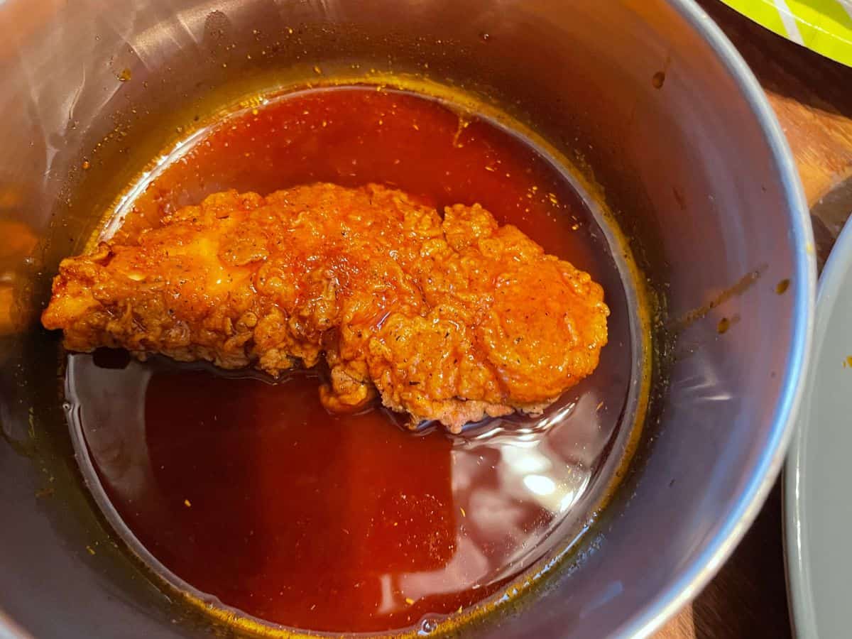 chicken tender coated in spicy oil in pot