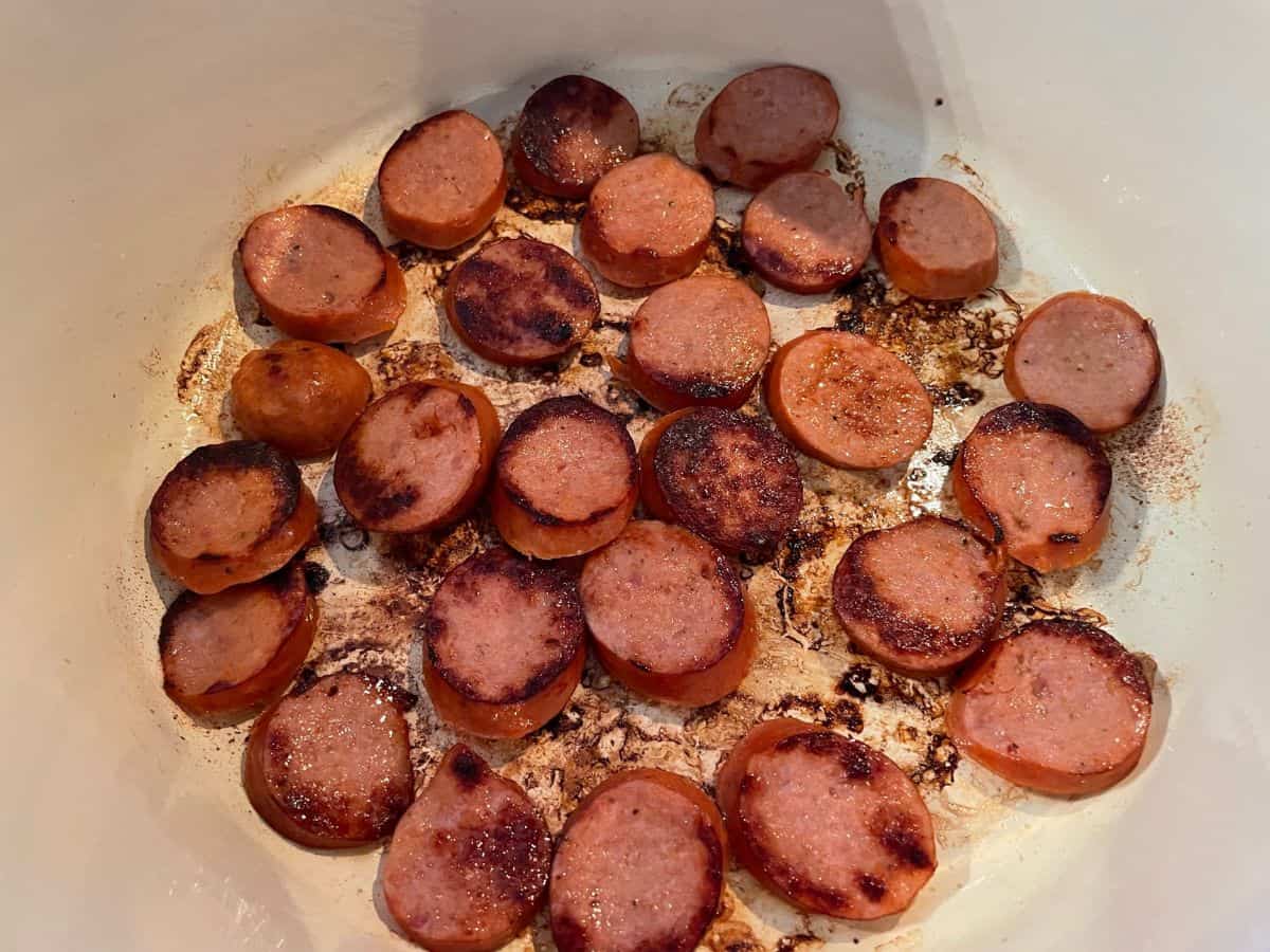 andouille sausage browning in dutch oven