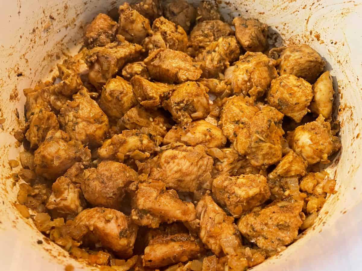 chicken and marinade added to pot of curry