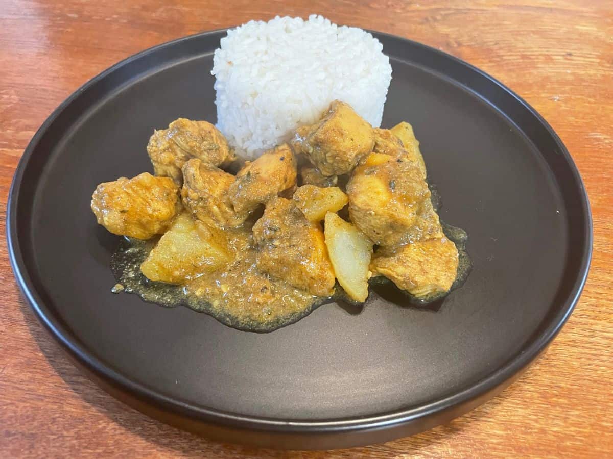 close up of curry chicken served with white rice