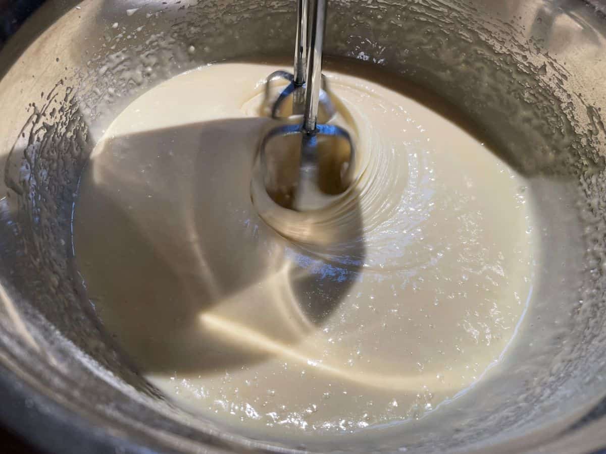 cake batter being mixed with hand mixer