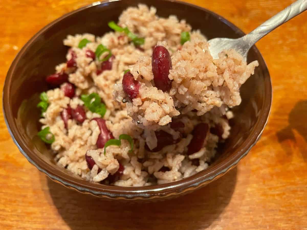 close up of rice and peas in a bowl, scooped with a fork