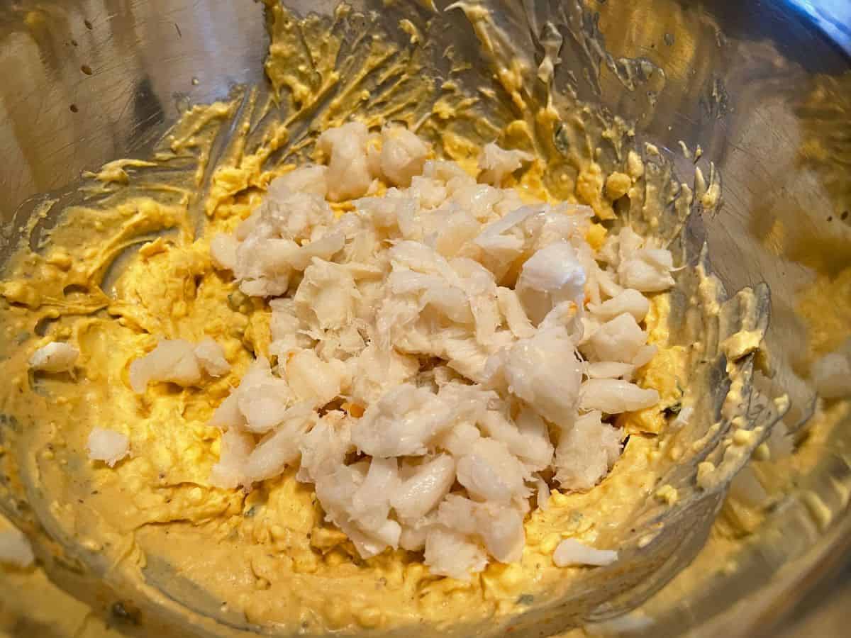 crab meat added to egg yolk mixture in large bowl
