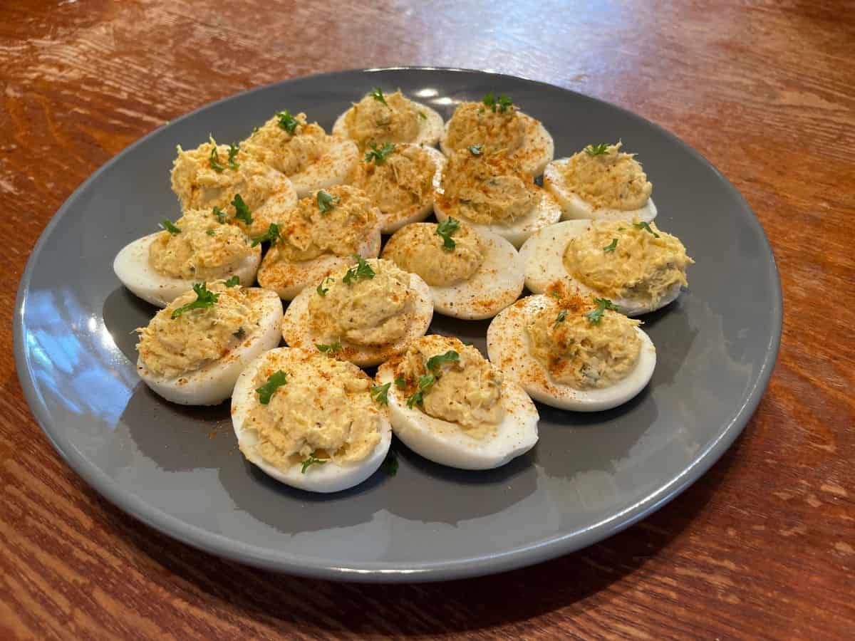 Served crab deviled eggs garnished with old bay and parsley