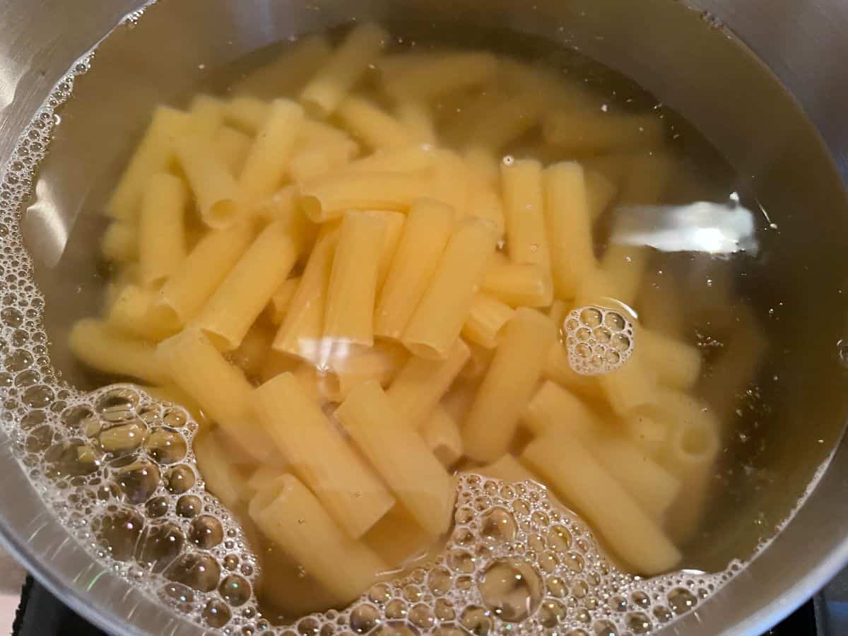 cooking rigatoni pasta in a large pot of salted water